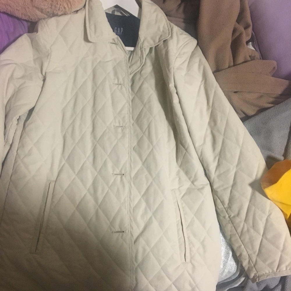 A women’s cream trench coat